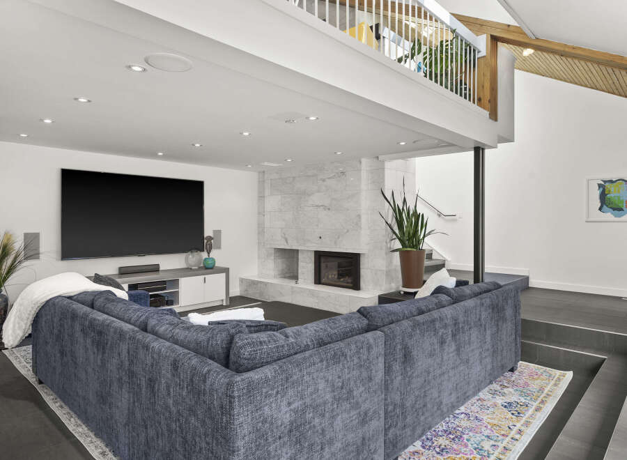 Step into luxury with this stunning living room, featuring a modern fireplace and a spacious, comfortable sectional sofa.