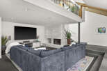 Step into luxury with this stunning living room, featuring a modern fireplace and a spacious, comfortable sectional sofa.