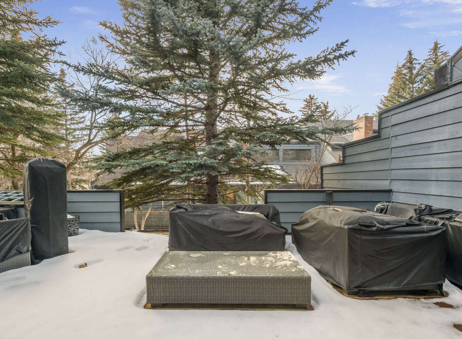 Enjoy outdoor living in this beautiful property! This outdoor space features a cozy seating area and a stylish coffee table, perfect for relaxing or entertaining.