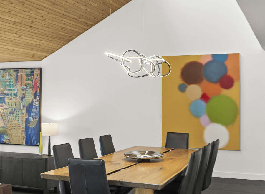 This stunning dining room showcases a modern aesthetic with its sleek design and high-end finishes.