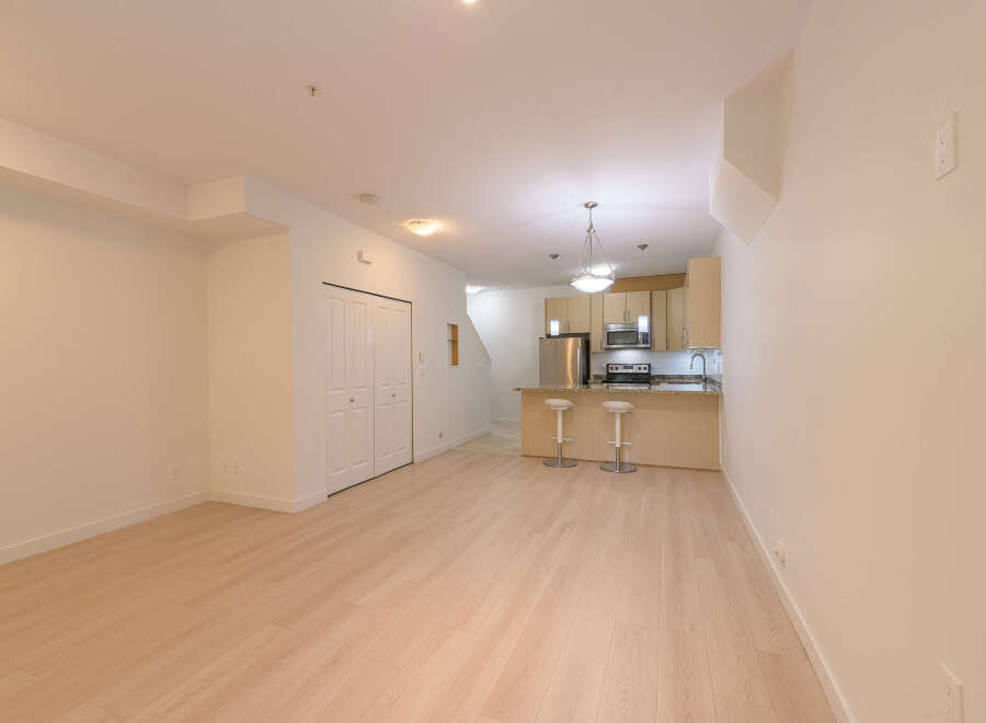 This stunning property boasts a modern kitchen with stainless steel appliances and a breakfast bar, perfect for entertaining.