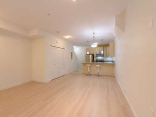 This stunning property boasts a modern kitchen with stainless steel appliances and a breakfast bar, perfect for entertaining.