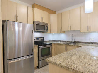 This stunning kitchen boasts modern appliances and ample storage space, perfect for culinary enthusiasts.