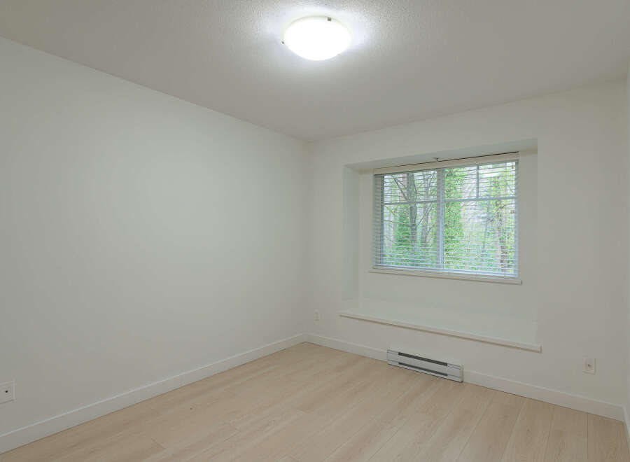 This bright and airy room features a neutral color palette, creating a versatile space for any design style.