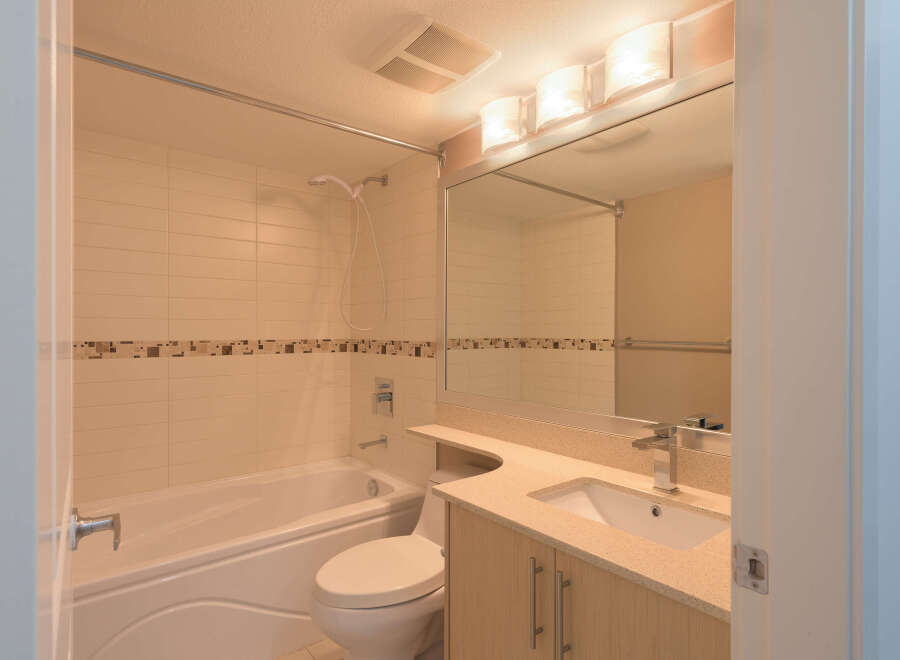 Step into this bright and modern bathroom, featuring a sleek vanity with ample storage and a stylish countertop.