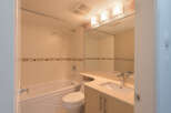 Step into this bright and modern bathroom, featuring a sleek vanity with ample storage and a stylish countertop.