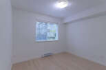 This bright and airy room features a large window with blinds, allowing for ample natural light.