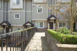 Discover modern living in this stunning townhome, featuring a beautifully landscaped entrance and a welcoming facade.