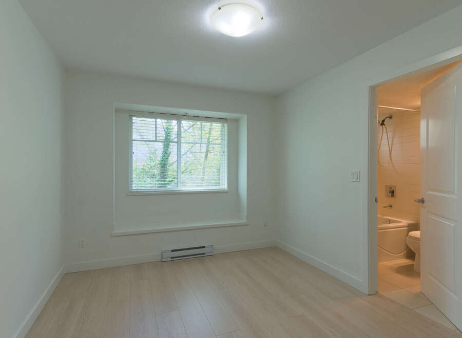 This bright and airy room features a large window that lets in plenty of natural light.