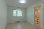 This bright and airy room features a large window that lets in plenty of natural light.
