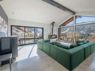 Experience luxury living in this stunning property, featuring a spacious living area with breathtaking mountain views.