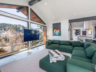 Experience luxury living in this stunning property, featuring a spacious living area with floor-to-ceiling windows that offer breathtaking views of the surrounding landscape.