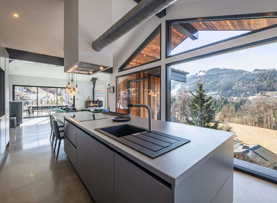 This stunning kitchen boasts a modern design with sleek cabinetry and a spacious island, perfect for culinary enthusiasts.