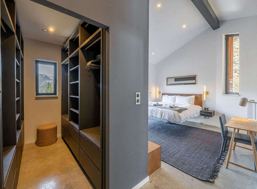 Step into luxury with this stunning property featuring a modern bedroom and a spacious walk-in closet.