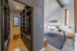 Step into luxury with this stunning property featuring a modern bedroom and a spacious walk-in closet.