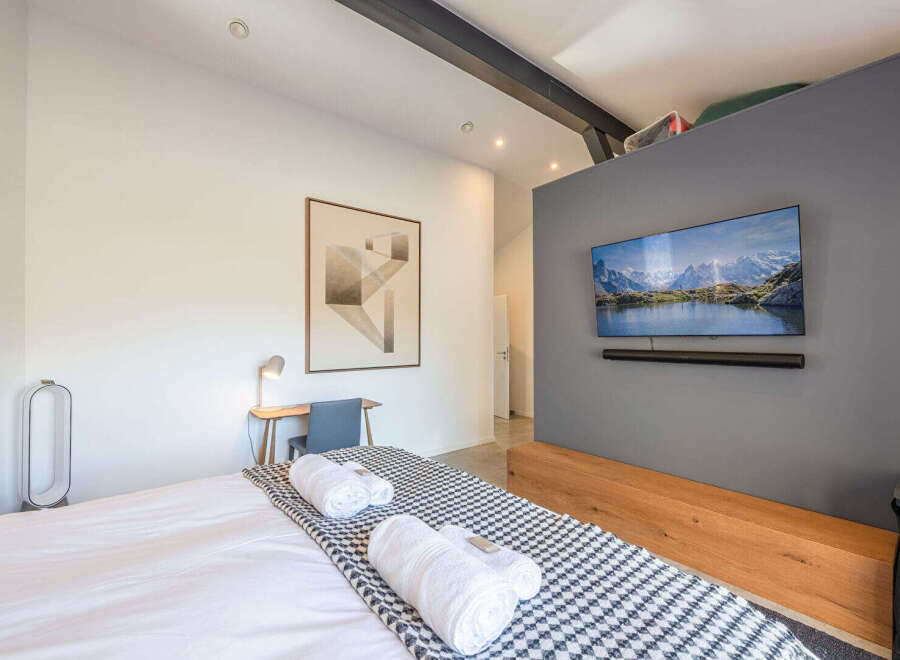 This modern bedroom offers a serene retreat with its minimalist design and thoughtful details.