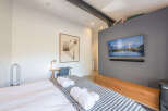 This modern bedroom offers a serene retreat with its minimalist design and thoughtful details.