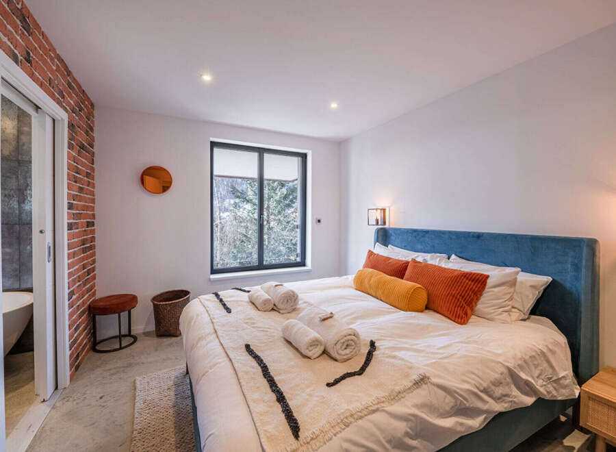 This stunning bedroom boasts a modern design with a touch of rustic charm.