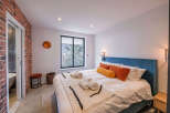 This stunning bedroom boasts a modern design with a touch of rustic charm.
