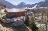 Nestled in a picturesque mountain setting, this stunning wooden cabin offers a serene retreat.