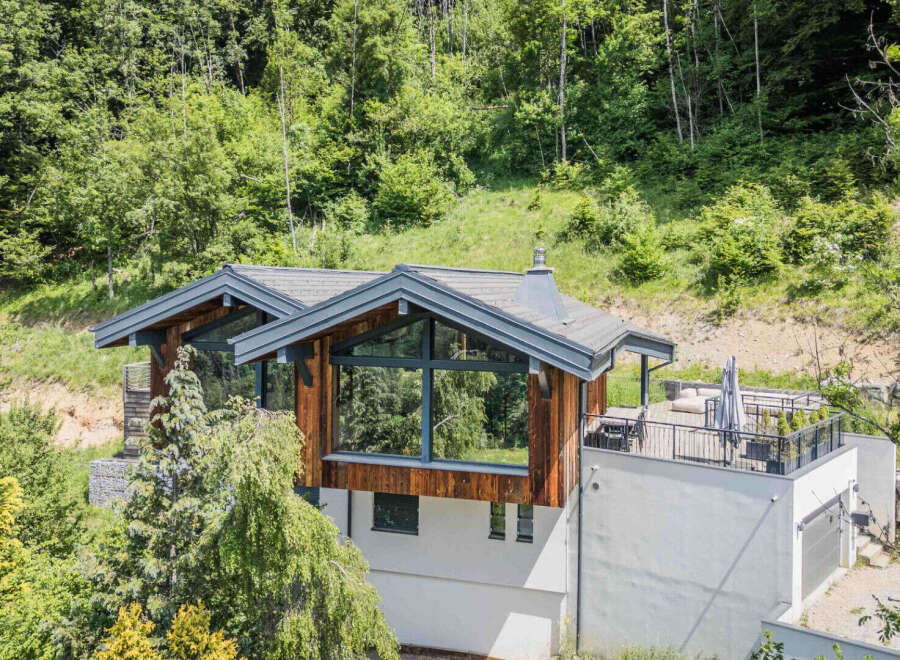 Discover a stunning modern home nestled in a serene, wooded setting.