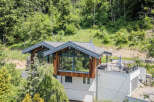 Discover a stunning modern home nestled in a serene, wooded setting.