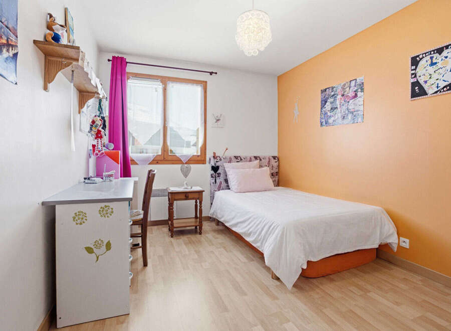 This charming bedroom features a cozy single bed, perfect for a guest room or a child's space.