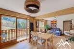 Experience the charm of this stunning property, featuring a bright and airy living space with a beautiful wooden dining set.