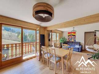 Experience the charm of this stunning property, featuring a bright and airy living space with a beautiful wooden dining set.