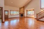 Experience the warmth and elegance of this spacious living room, featuring a stunning stone fireplace as the centerpiece.
