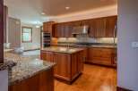Experience luxury in this stunning kitchen featuring custom cherry wood cabinetry and granite countertops.