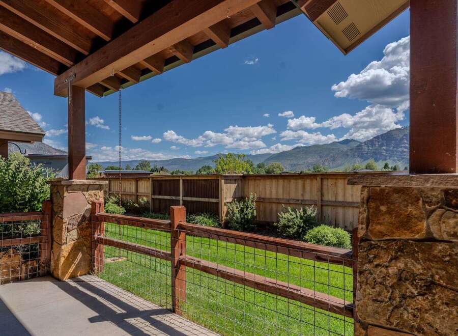 Enjoy the stunning mountain views from this covered patio, perfect for outdoor living.