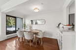 This stunning dining area boasts a modern design with sleek lines and a bright, airy atmosphere.