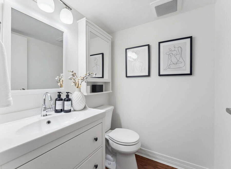 This modern bathroom features a sleek white vanity with a stylish sink and faucet.