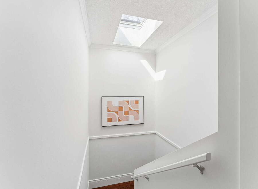 This stunning property features a bright and airy staircase with a modern design.