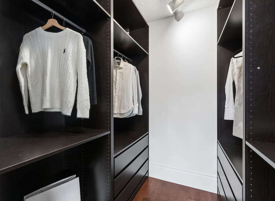 Step into luxury with this meticulously designed walk-in closet, offering ample storage and organization.