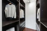 Step into luxury with this meticulously designed walk-in closet, offering ample storage and organization.