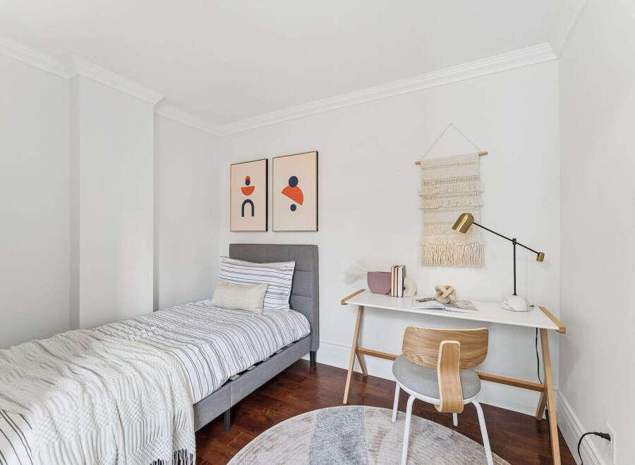 This cozy bedroom features a stylish design with a comfortable bed and a functional desk area.