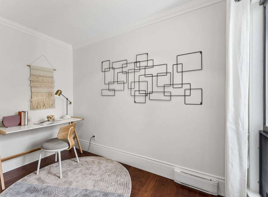 This stylish home office features a modern desk, a comfortable chair, and a unique wall art piece, creating a productive and inspiring workspace.