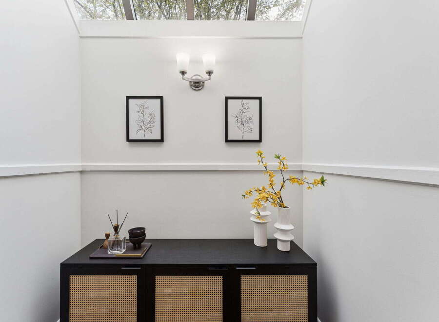 This stunning entryway showcases a modern design with clean lines and a touch of nature.