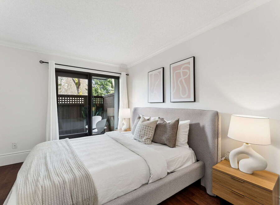 This stunning bedroom offers a serene retreat with its modern design and ample natural light.