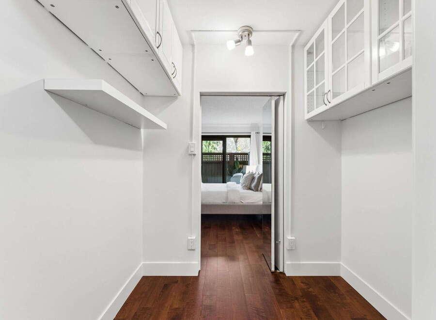Step into this bright and airy space, featuring pristine white walls and elegant hardwood floors.