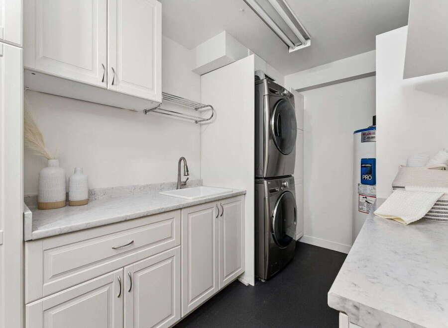 This modern laundry room boasts a sleek design with ample storage and functionality.
