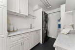 This modern laundry room boasts a sleek design with ample storage and functionality.