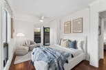 Step into this bright and airy bedroom, featuring a comfortable bed with stylish bedding and decorative pillows.