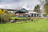 Discover a charming property featuring a picturesque pond and lush green lawns, perfect for relaxation and outdoor activities.