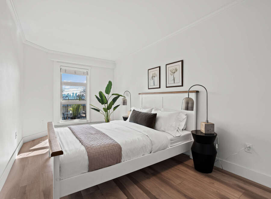 This stunning bedroom offers a serene retreat with its bright, airy design and modern aesthetic.