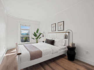 This stunning bedroom offers a serene retreat with its bright, airy design and modern aesthetic.