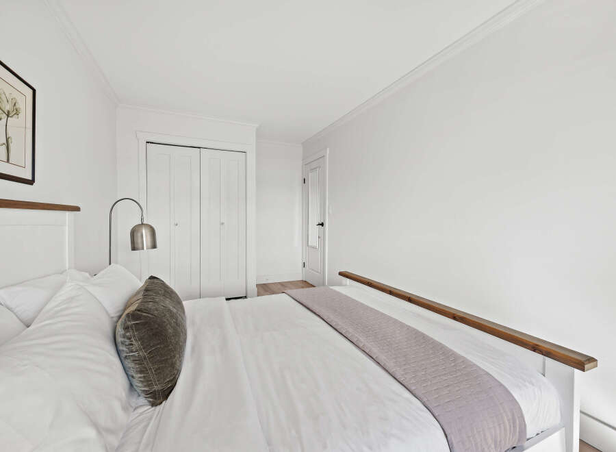 This inviting bedroom offers a serene retreat with its bright, airy ambiance and minimalist design.