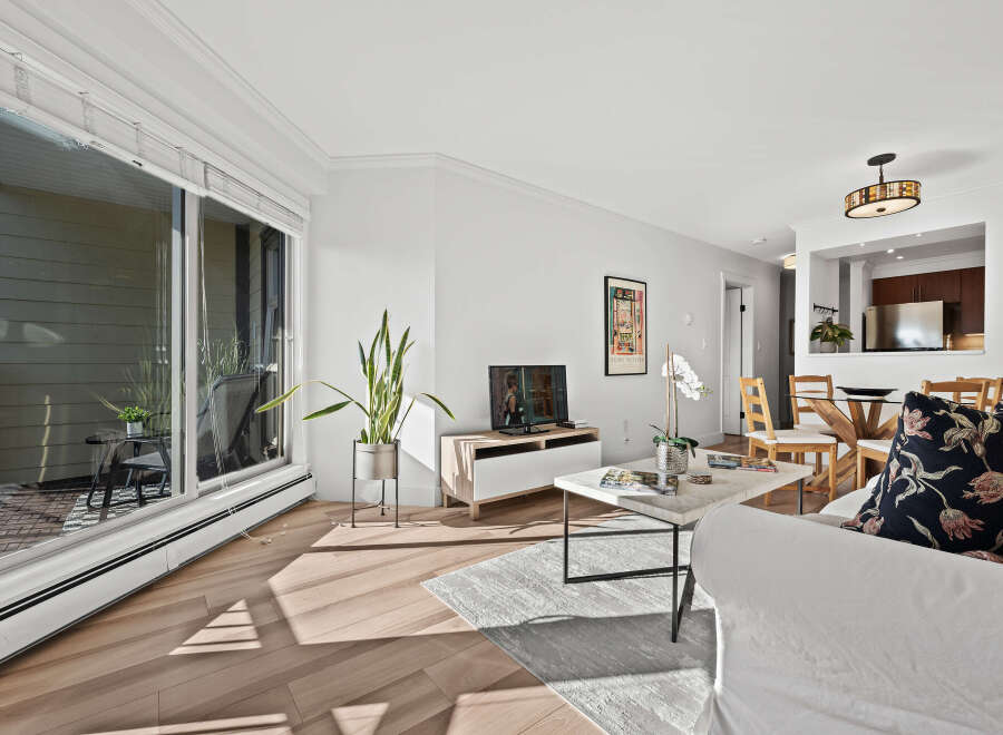 This stunning living space boasts a bright and airy ambiance, perfect for modern living.